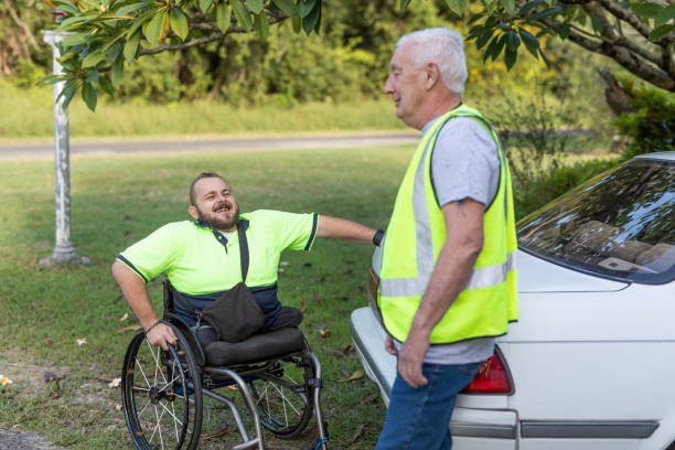 A participant enjoying time outdoors in the community, supported by a friendly worker